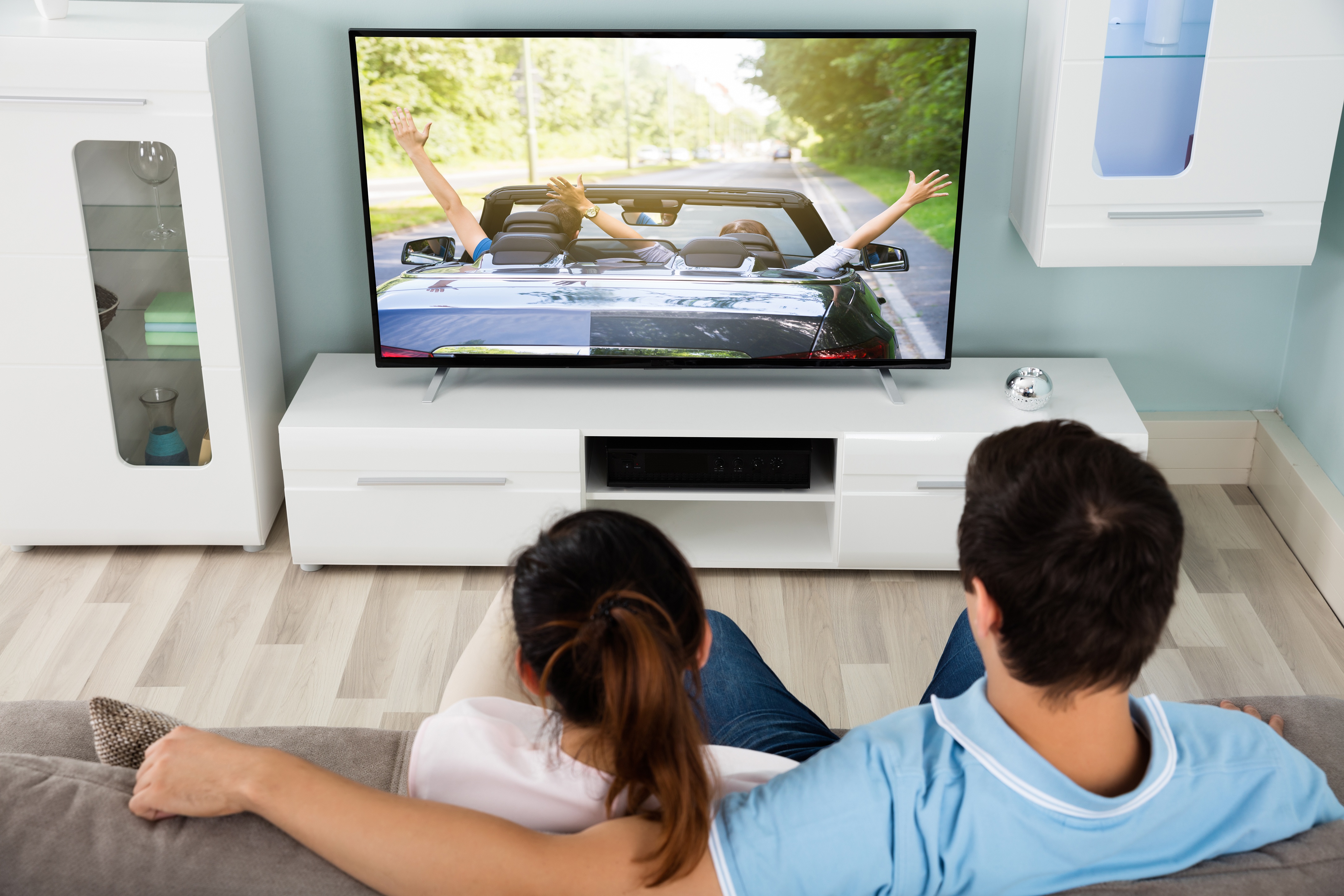 A group of people watching a movie on a big-screen TV